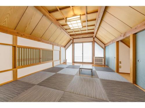a large room with a table in the middle of it at BOOKMARQ yufuin - Vacation STAY 13695 in Yufuin