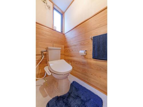 a bathroom with a toilet and a blue rug at BOOKMARQ yufuin - Vacation STAY 13695 in Yufuin