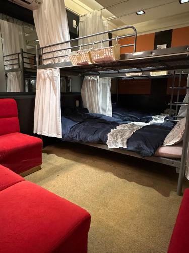a room with two bunk beds and a couch at Guest House Tosa Otesujihana Dormitory women only- Vacation STAY 14354 in Kochi