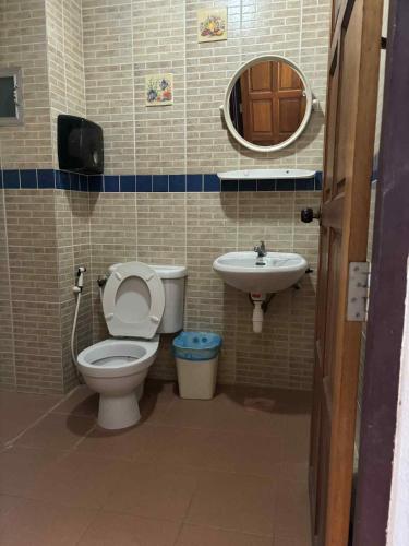 a bathroom with a toilet and a sink at The Sunshine hostel and hotel in Ko Lanta