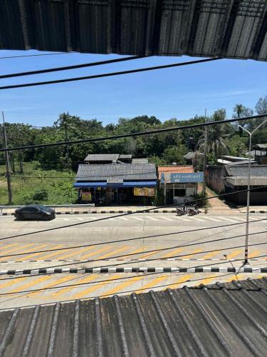 a view of a road with a building in the background at The Sunshine hostel and hotel in Ko Lanta