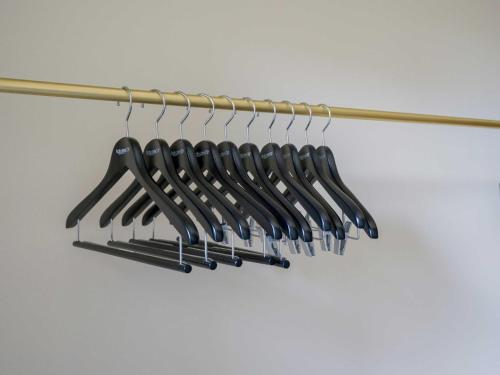 a bunch of black utensils on a rack at Rakuten STAY VILLA Kamogawa A with Pool and Terrace and sauna Capacity of 12 persons in Kamogawa
