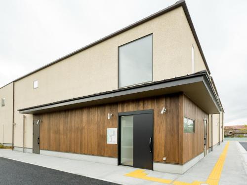 an office building with a black door at Rakuten STAY VILLA Kamogawa A with Pool and Terrace and sauna Capacity of 12 persons in Kamogawa