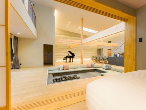 a bedroom with a fireplace in the middle of a living room at Rakuten STAY VILLA Kamogawa A with Pool and Terrace and sauna Capacity of 12 persons in Kamogawa