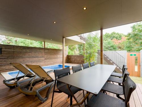 a dining room with a table and chairs at Rakuten STAY VILLA Kamogawa A with Pool and Terrace and sauna Capacity of 12 persons in Kamogawa