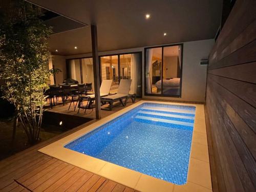 a swimming pool in the backyard of a house at Rakuten STAY VILLA Kamogawa A with Pool and Terrace and sauna Capacity of 12 persons in Kamogawa
