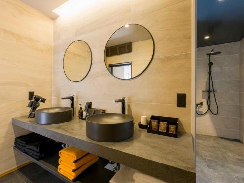 a bathroom with two sinks and a mirror at Rakuten STAY VILLA Kamogawa Building A with Pool and Terrace and sauna Capacity of 12 persons Pets allowed in Kamogawa