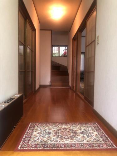 an empty hallway with a rug on a wooden floor at Hotel Ryokan Togenkyo - Vacation STAY 97146v in Ise
