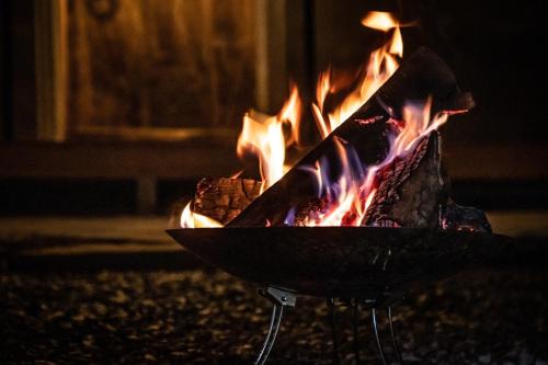 a fire in a grill with flames in it at Ooka Tsuji - tsuji-oooka - - Vacation STAY 01156v in Chikuma