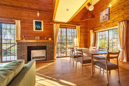 a living room with a fireplace and a table and chairs at Nasu Grand Villa - Vacation STAY 13860 in Nasu-yumoto