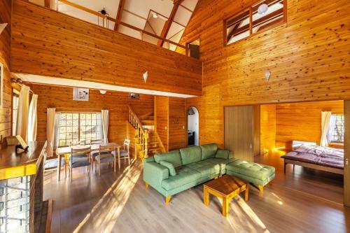 a living room with a green couch and a table at Nasu Grand Villa - Vacation STAY 13860 in Nasu-yumoto