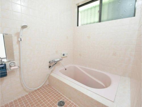 a bath tub in a bathroom with a window at Minpaku Yamamoto - Vacation STAY 13869 in Izumiotsu