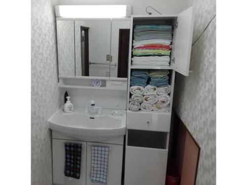 a small bathroom with a sink and a mirror at Minpaku Yamamoto - Vacation STAY 13869 in Izumiotsu