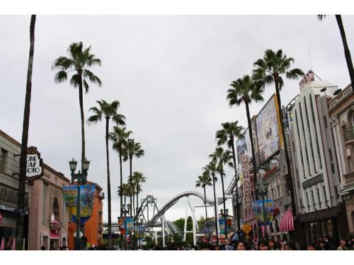 a city street with a roller coaster in the background at Minpaku Yamamoto - Vacation STAY 13869 in Izumiotsu