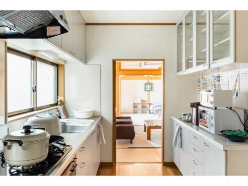 a kitchen with a stove and a sink and a room at Ichigo Ichie Nikko - Vacation STAY 09411v in Nikko