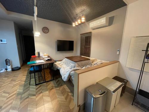 a room with a bed and a desk in it at Guest House Numazu Port - Vacation STAY 18050v in Numazu