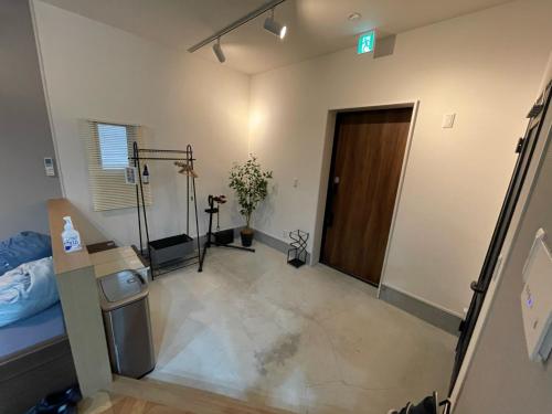 a room with a bedroom with a door and a room with at Guest House Numazu Port - Vacation STAY 18050v in Numazu