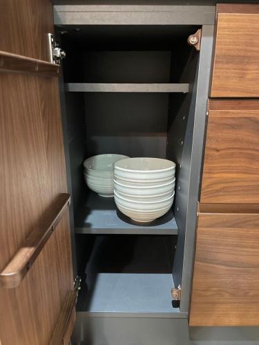 a cupboard with two plates and bowls in it at Guest House Numazu Port - Vacation STAY 18050v in Numazu