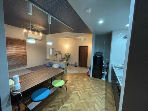 a kitchen with a table and chairs in a room at Guest House Numazu Port - Vacation STAY 18050v in Numazu