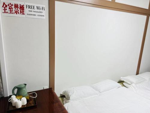 a bedroom with a bed and a table and a sign at FUKUINN - Vacation STAY 19245v in Takamatsu
