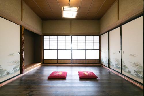two red mats in a room with large windows at VillageOMOYA - Vacation STAY 24662v in Ina