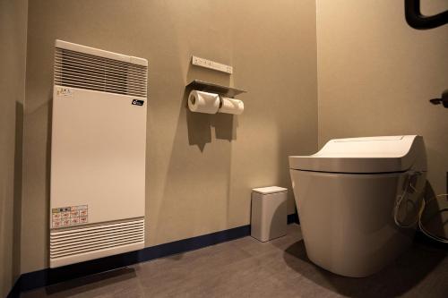 a bathroom with a toilet and a roll of toilet paper at UU HOME - Vacation STAY 28498v in Biei