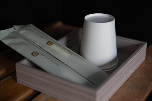 a vase and a candle on a wooden table at Agatsuma-gun - House - Vacation STAY 26682v in Kusatsu