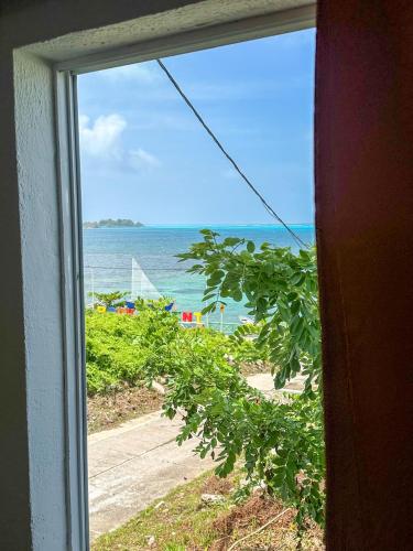 a view of the ocean from a window at Posada Three Cay Suites in Providencia