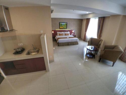 a large hotel room with a bed and a bathroom at Asialink Premier in Karawang