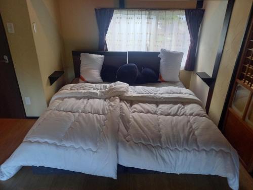 a large bed in a bedroom with a window at Amami - House - Vacation STAY 35269v in Amami