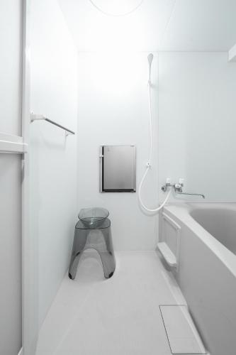 a white bathroom with a toilet and a sink at Starlight in Sapporo
