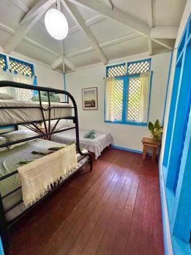 a bedroom with two bunk beds in a room at Villas Itaita Beach Cabins in Punta Uva