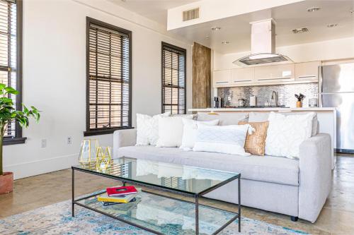 a living room with a couch and a glass table at Bright lights central Downtown in Los Angeles