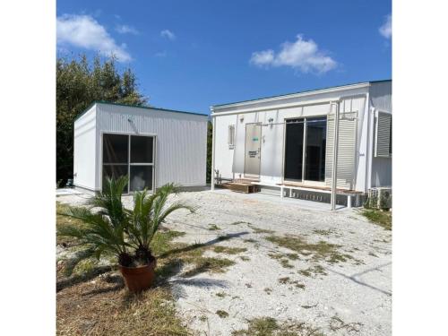 a house with a palm plant in front of it at Kai sou - Vacation STAY 42232v in Tateyama