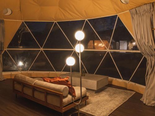 a room with a tent with a couch and lights at BAMBOO RESORT MIHAMA TSUNAGI - Vacation STAY 43081v in Noma