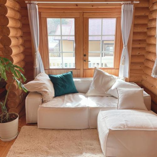 a living room with a white couch and a window at 'OLI' OLI tree - Vacation STAY 39608v in Takashima