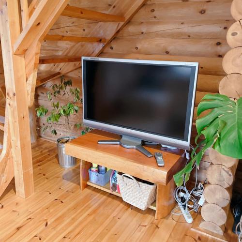 a television sitting on a wooden table in a room at 'OLI' OLI tree - Vacation STAY 39608v in Takashima