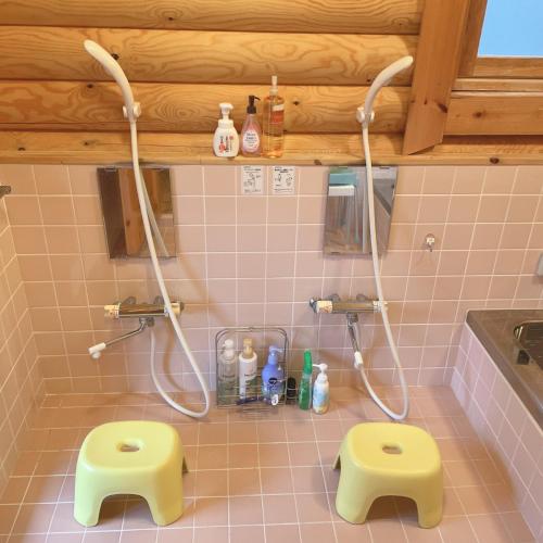 a bathroom with a shower and two yellow stools at 'OLI' OLI tree - Vacation STAY 39608v in Takashima