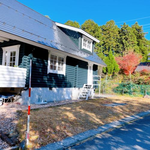 a house with a black roof and a yard at 'OLI' OLI tree - Vacation STAY 39608v in Takashima