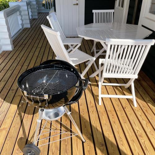 a grill on a deck with chairs and a table at 'OLI' OLI tree - Vacation STAY 39608v in Takashima