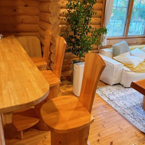 a living room with wooden tables and chairs at 'OLI' OLI tree - Vacation STAY 39608v in Takashima