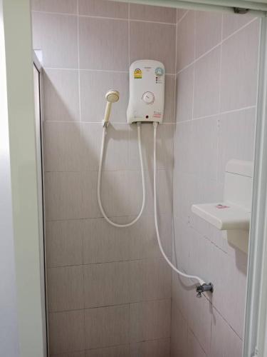 a shower with a hose in a bathroom at Rimpuhill resort in Sattahip