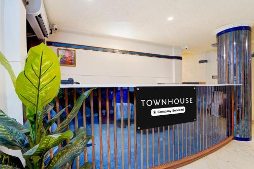 a view of a room with a tlv house sign on the wall at Super Townhouse Green Field Stadium Karyavattom in Kazhakuttam