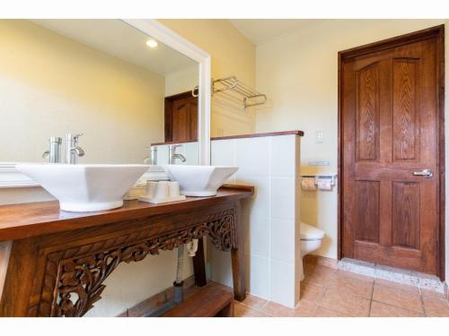a bathroom with two white sinks and a mirror at Nagura Village - Vacation STAY 61123v in Kabira