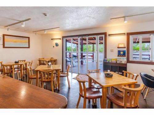a dining room with wooden tables and chairs at Nagura Village - Vacation STAY 61123v in Kabira