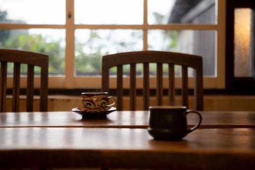 a wooden table with two cups on top of it at SAKURA HOUSE - Vacation STAY 65303v in Sonai