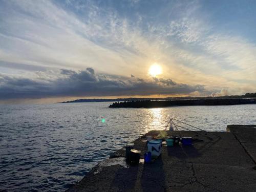 a sun setting over a large body of water at Oasis Wadaura - Vacation STAY 89769v in Kamogawa