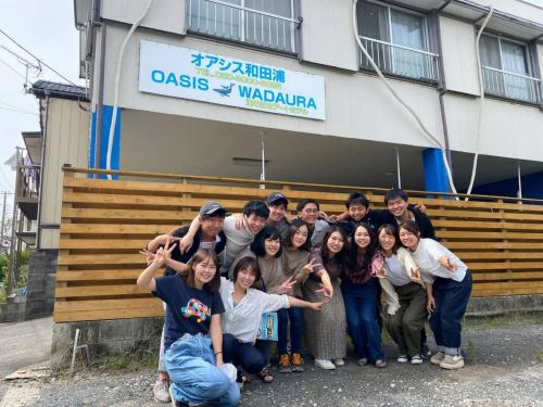 a group of people posing for a picture in front of a building at Oasis Wadaura - Vacation STAY 89769v in Kamogawa