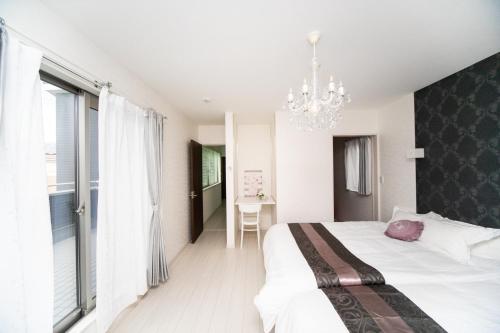 a bedroom with a large bed and a chandelier at Takashima - House - Vacation STAY 14172 in Takashima