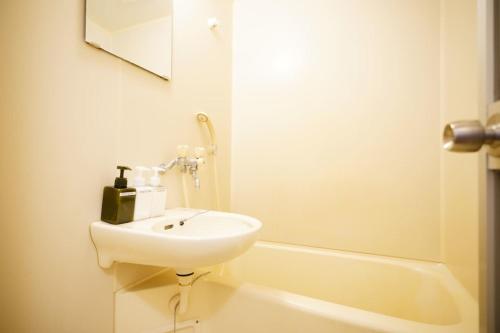 a bathroom with a sink and a bath tub at Maison Tsunami - Vacation STAY 79560v in Naha